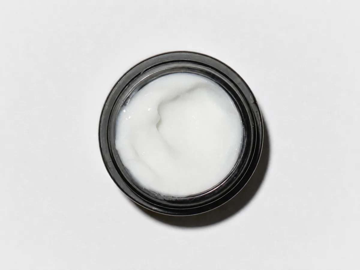 Open RAWDOG Caffeine Under Eye Cream showing its smooth cream texture