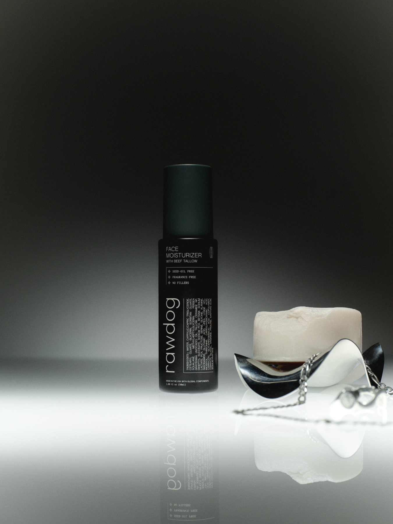 RAWDOG Face Moisturizer beside stone and metal props