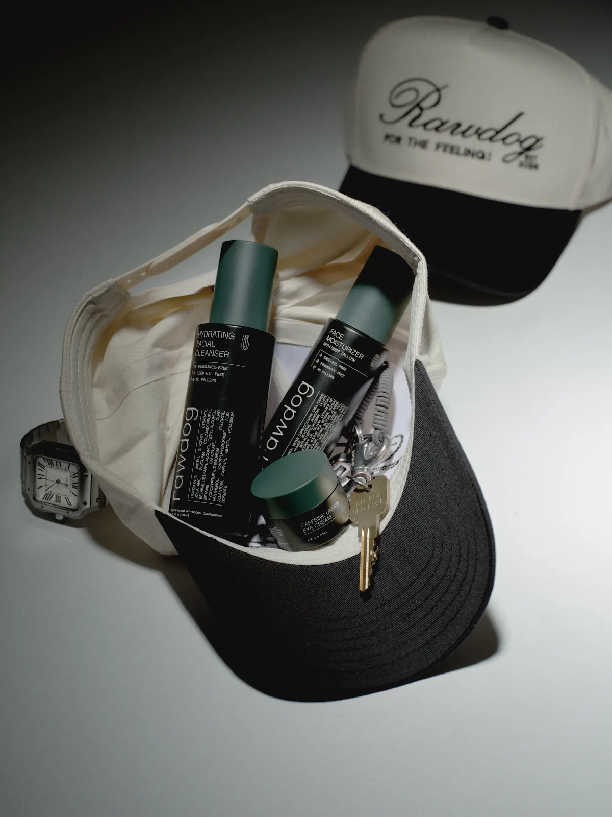 RAWDOG cleanser, moisturizer, and eye cream arranged as a daily skincare routine