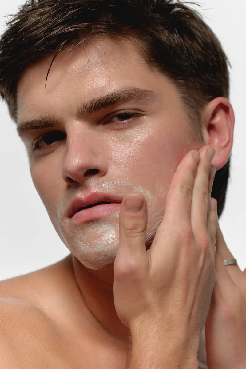 Man applying RAWDOG Hydrating Facial Cleanser to his face