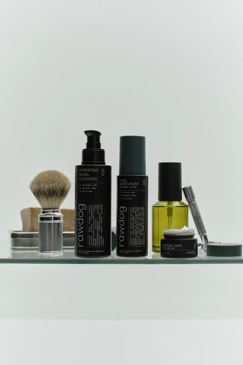 RAWDOG cleanser, moisturizer, and eye cream arranged on a grooming shelf