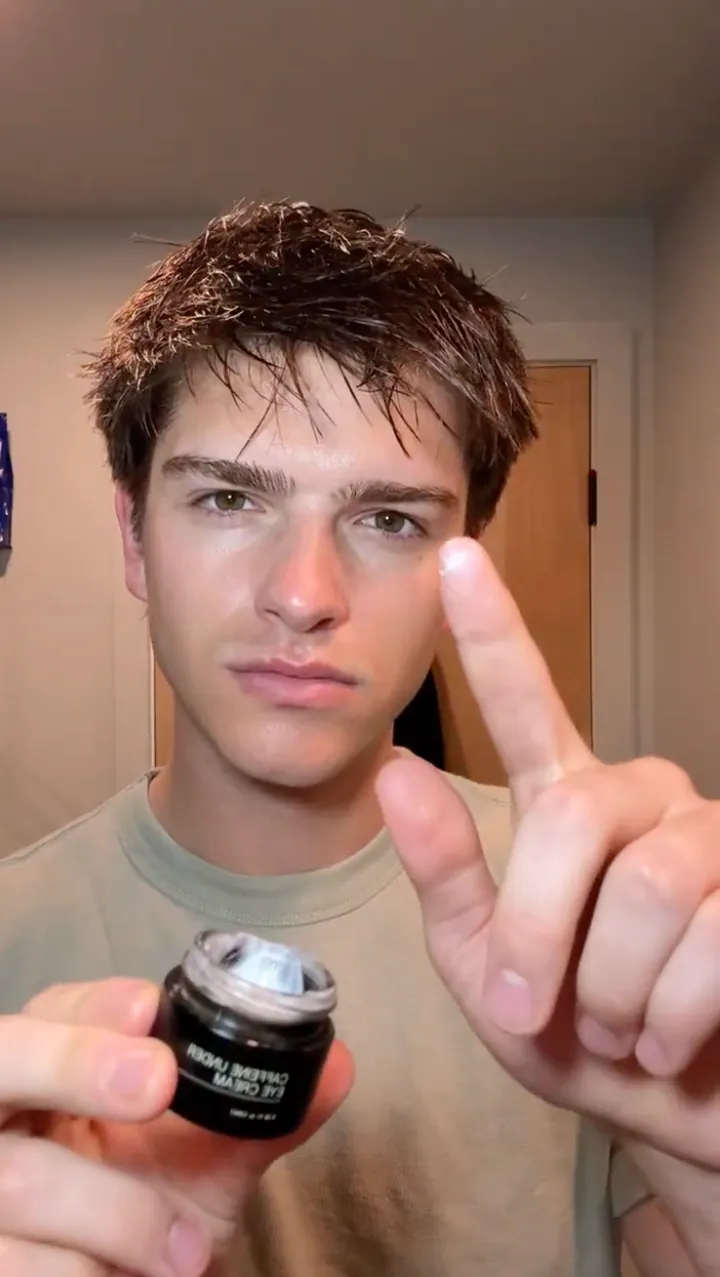 Man showing the amount of RAWDOG Eye Cream to apply